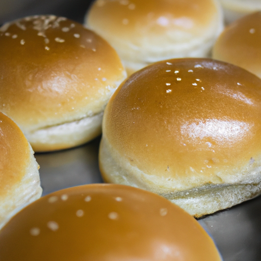 Freshly baked slider buns, lightly toasted and ready to be filled with juicy cheeseburger patties.